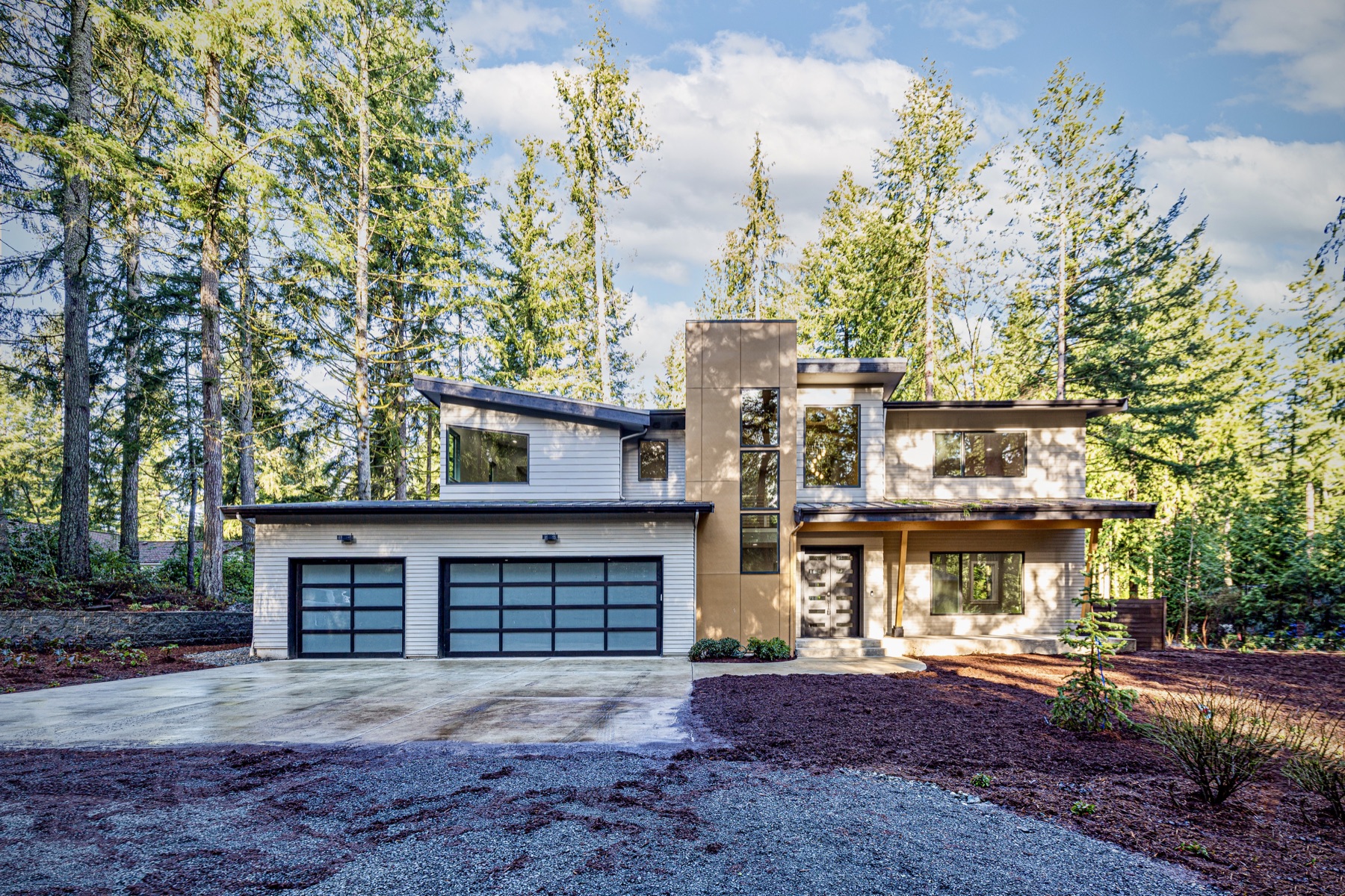 Completed modern home surrounded by trees
